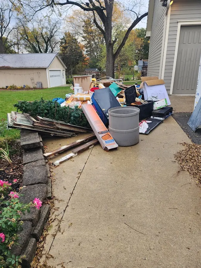Dumpster being loaded with debris for 12 Yard Dumpster Rental in Ellsworth